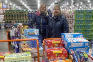 BGC Okanagan staff shopping for food donations for Adopt-A-Family campaign.